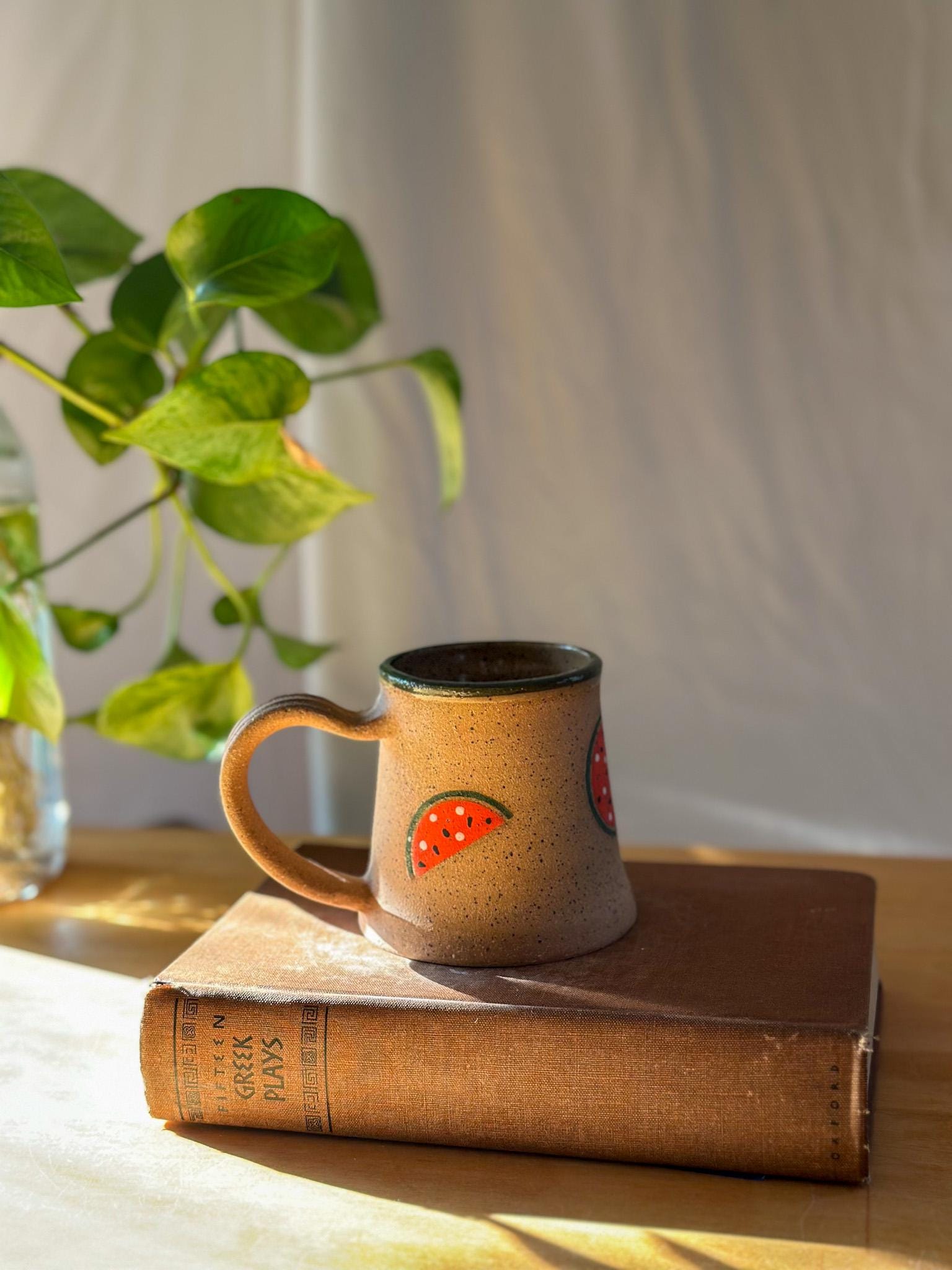 green and red and brown tea mug