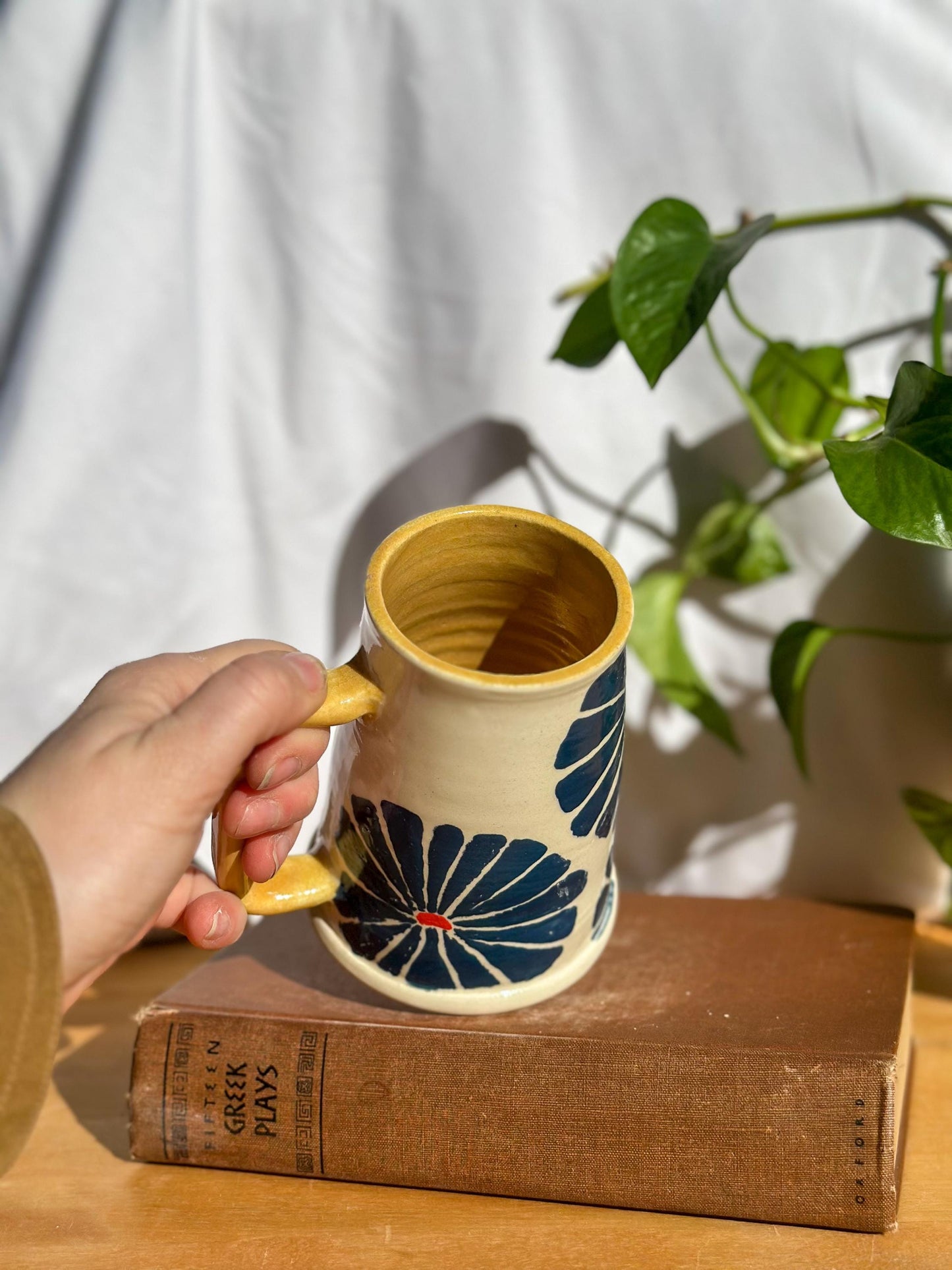 yellow handle on ceramic handmade mug