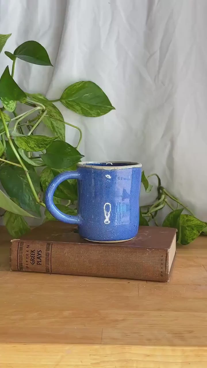 white rimmed blue speckled coffee mug