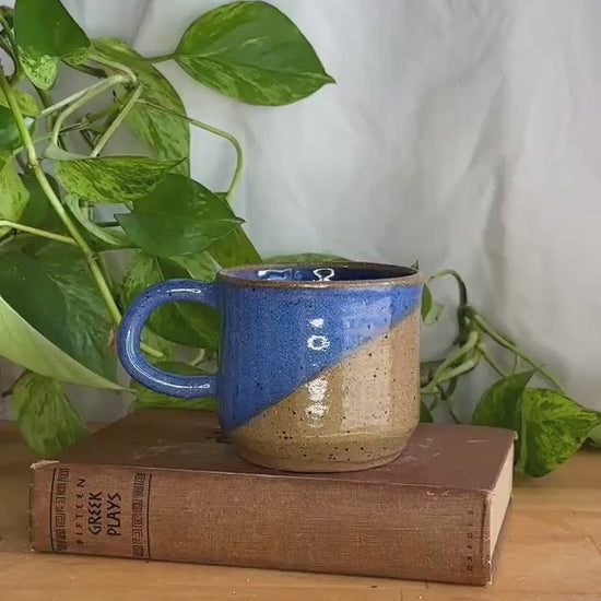 half dipped blue and brown speckled coffee mug