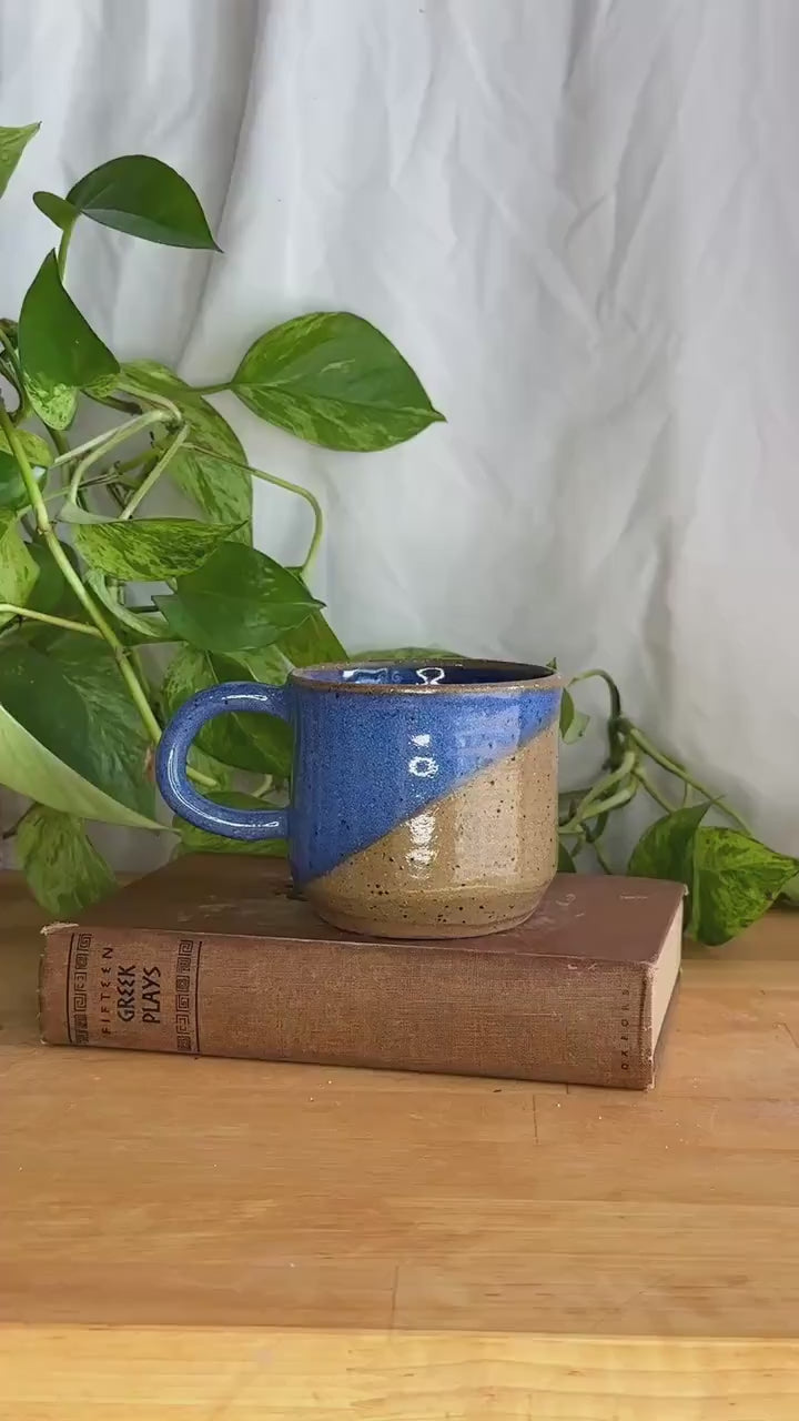 half dipped blue and brown speckled coffee mug